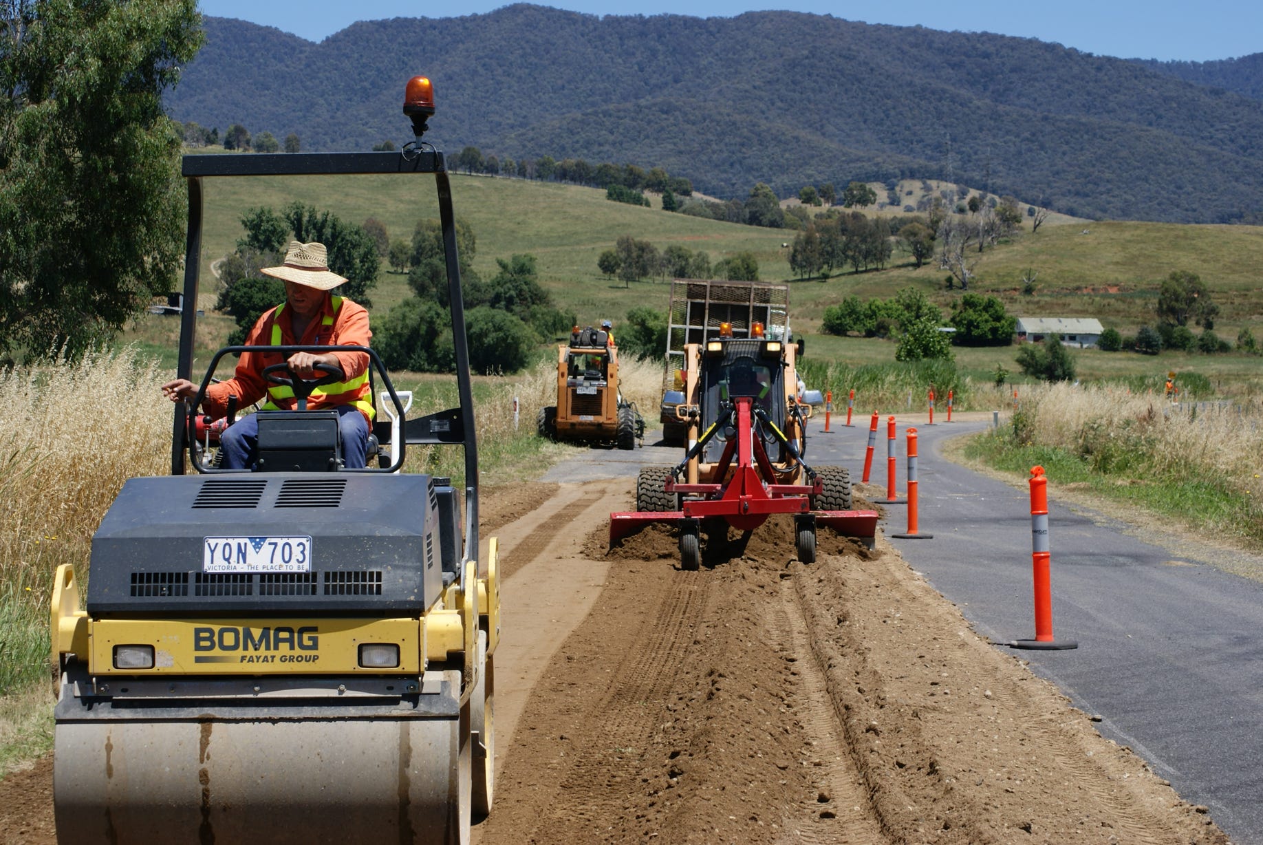 Road crew repairing a failed area of sealed road with PolyCom Stabilising Aid from Earthco Projects.